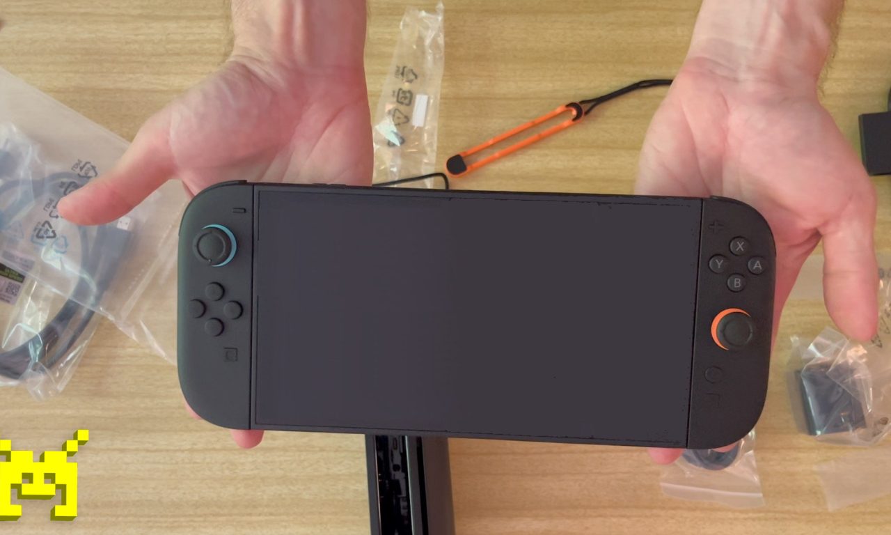 Birds-eye view of two hands holding a recently unboxed Nintendo Switch 2